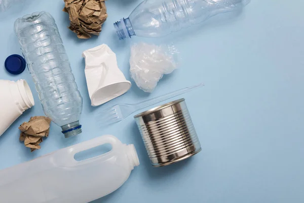 Top view of rubbish for recycling on a blue background