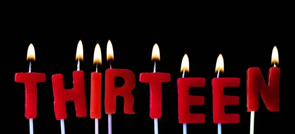 Thirteen Spellt Out Red Birthday Candles Black Background — Stock Photo, Image