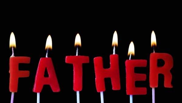 Father spellt out in red birthday candles against a black background — Stock Photo, Image