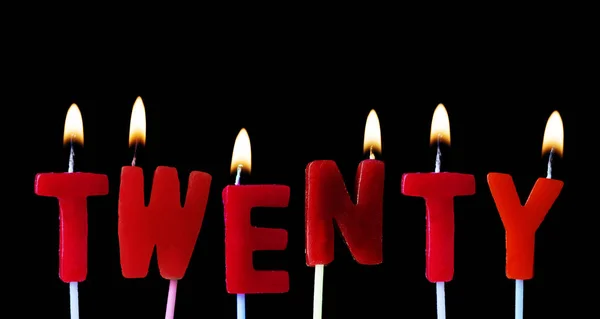 Twenty spellt out in red birthday candles against a black background — Stock Photo, Image