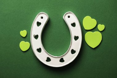 St Patricks Day green background with lucky horseshoe clipart