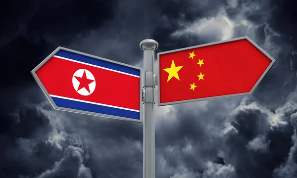 China e Coreia do Norte sinalizam bandeira movendo-se em direção diferente. Renderização 3D — Fotografia de Stock