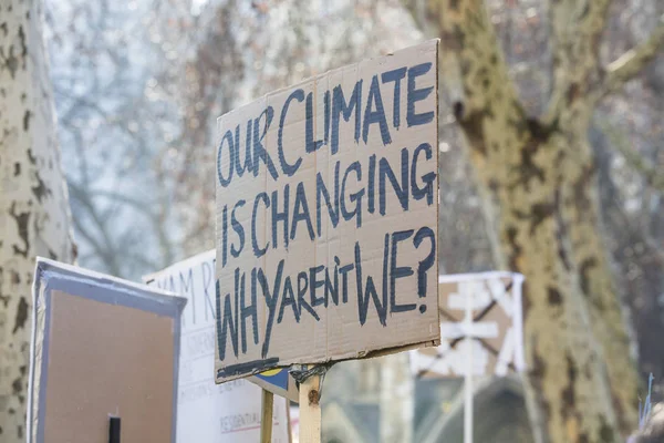 Protestors holding climate change banners at a protest — Stock Photo, Image