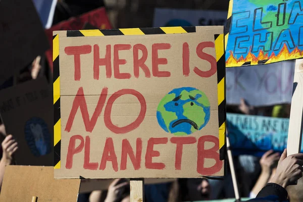 Protestors holding climate change banners at a protest — Stock Photo, Image