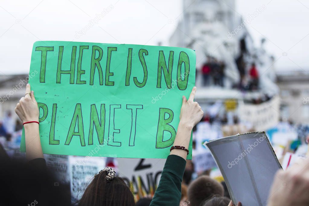 People with banners protest as part of a climate change march