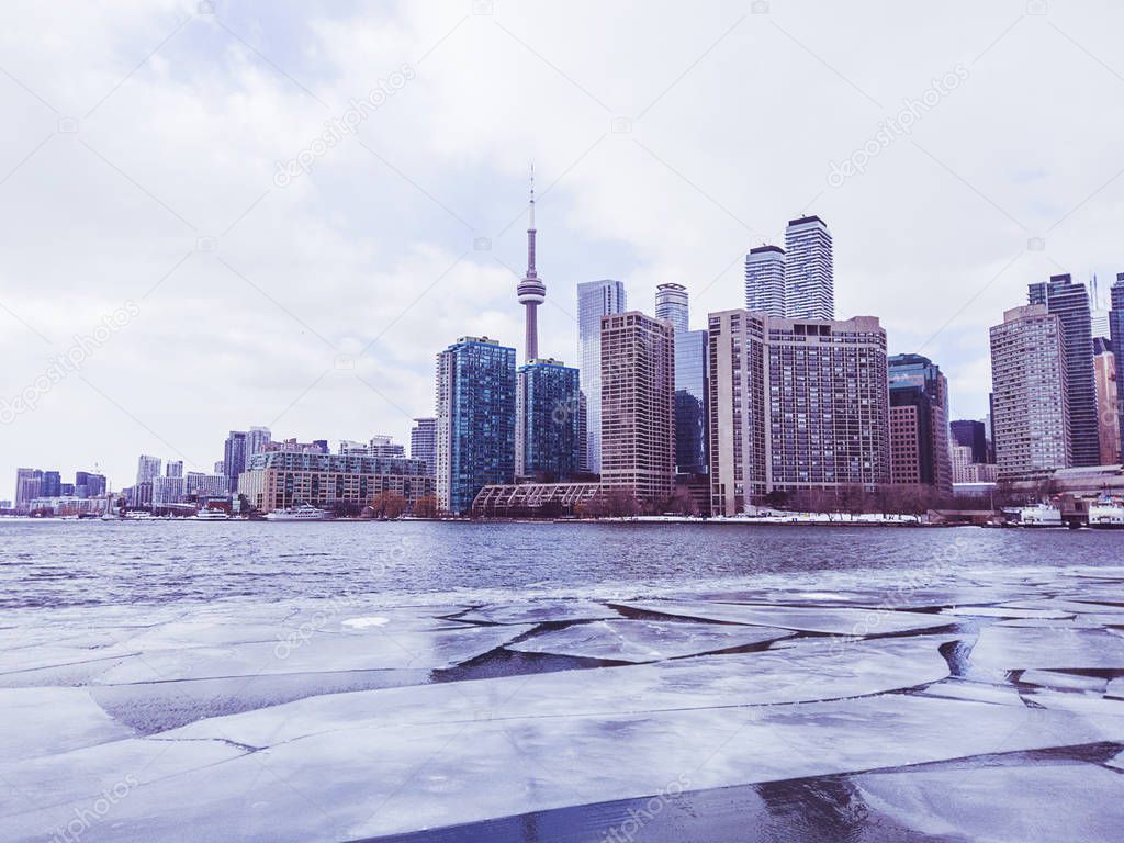 View of Toronto city skyline form a boat as it crosses the frozen Lake Ontario