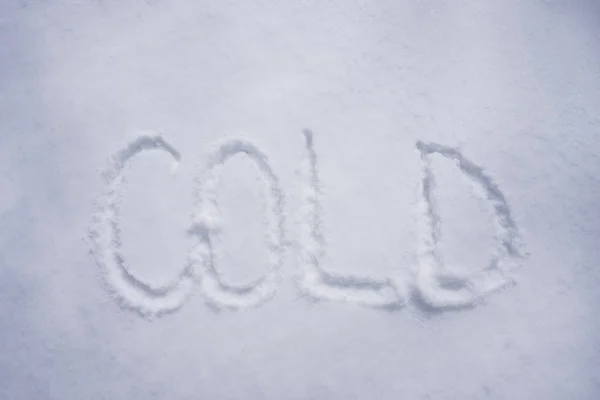 Palabra fría escrita en el fondo de nieve —  Fotos de Stock