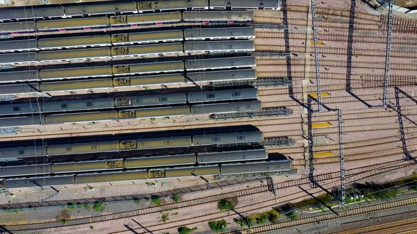 Aerial view over passenger trains in rows at a station — Stock Photo, Image