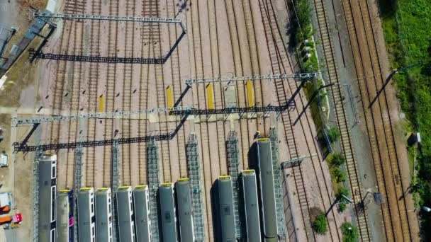 Aerial view over passenger trains in rows at a station — Stock Video