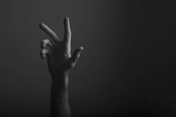 Masculino mão aberta gesto sobre um fundo escuro — Fotografia de Stock