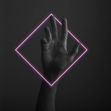 Soyut neon ışık parıltısı ile karanlık bir arka plan üzerinde erkek açık el hareketi