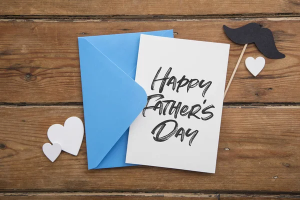 Happy Fathers day card and envelope with mustache and love hearts — Stock Photo, Image