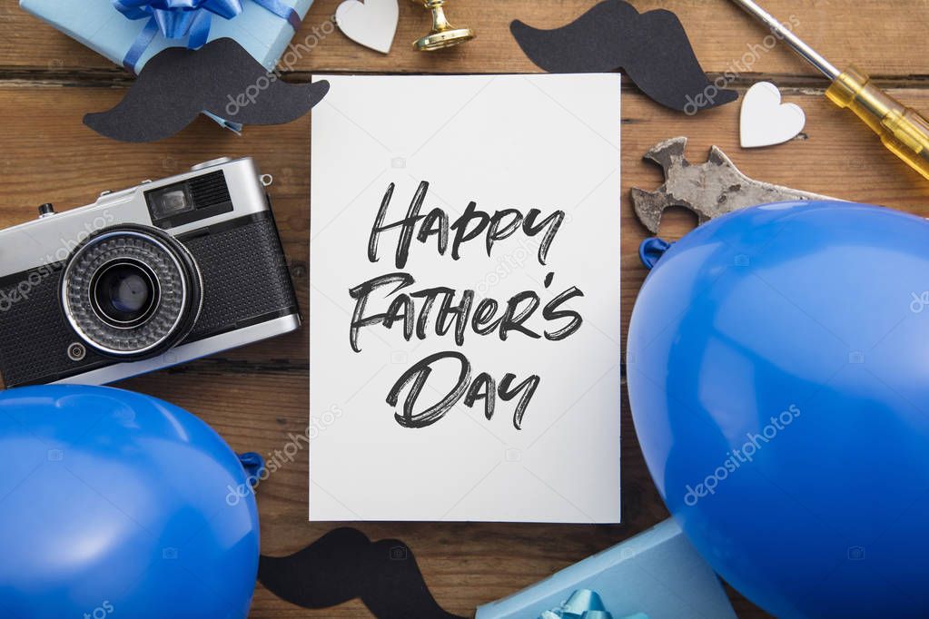 Happy Fathers day card composition with gifts, mustache, trophy, camera