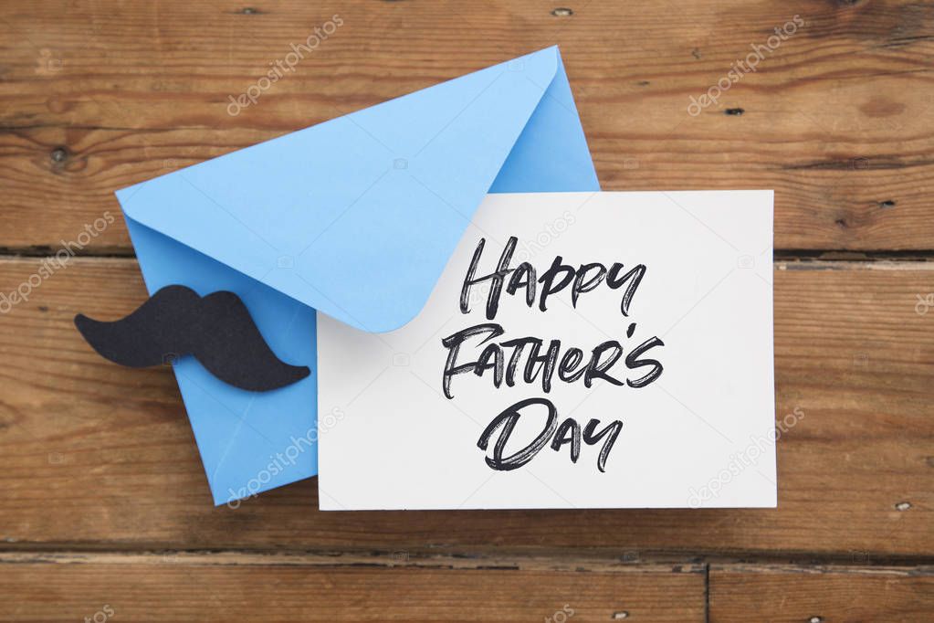Fathers day card and blue envelope with paper mustache