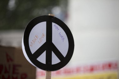 Bir kişi bir protesto bir barış işareti afiş tutar