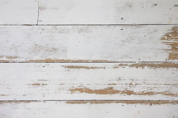 White wooden floorboards. Distressed worn floorboard background painted white