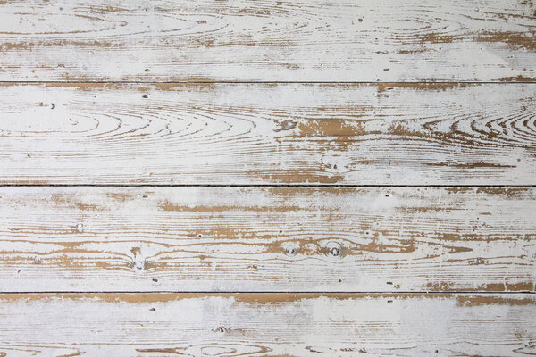 White wooden floorboards. Distressed worn floorboard background painted white