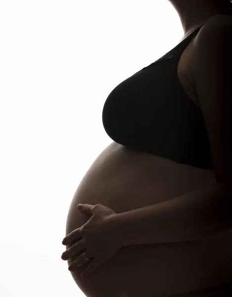 Mulher grávida com uma barriga de bebê silhueta em um fundo branco — Fotografia de Stock