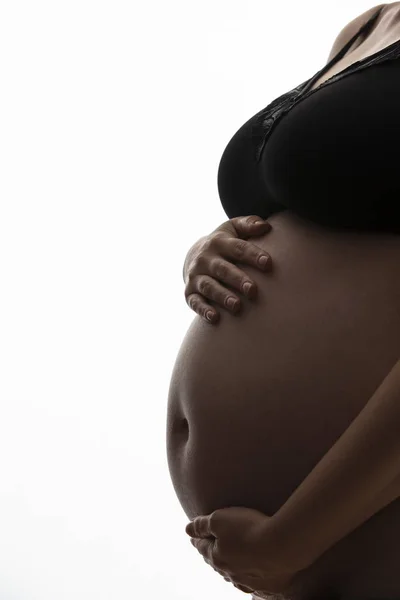 Mulher grávida com uma barriga de bebê silhueta em um fundo branco — Fotografia de Stock