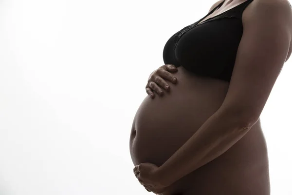 Mujer embarazada con un bulto de bebé silueta sobre un fondo blanco — Foto de Stock