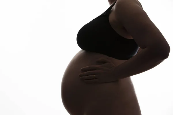 Mulher grávida com uma barriga de bebê silhueta em um fundo branco — Fotografia de Stock