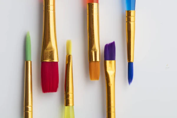 Colourful creative paintbrush art supply background — Stock Photo, Image