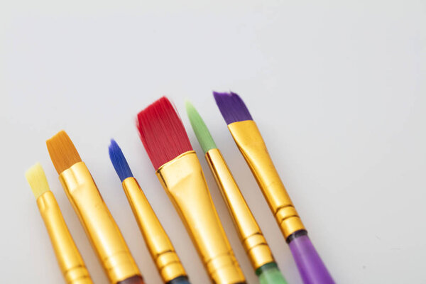 Colourful creative paintbrush art supply background