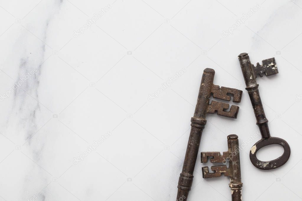 Vintage old fashioned keys on a marble background with copy space
