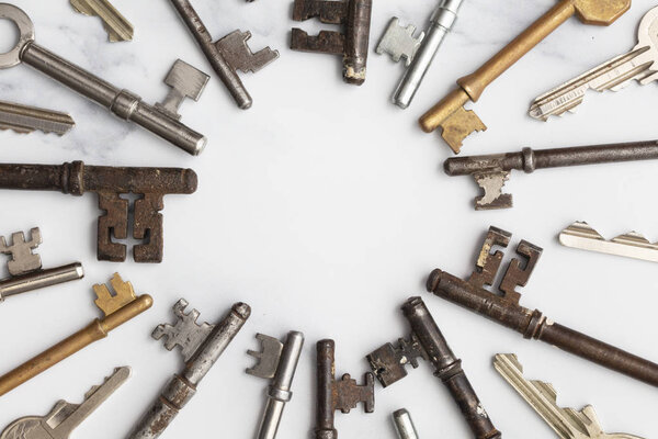 Frame of vintage keys on white background. Safety and security concept