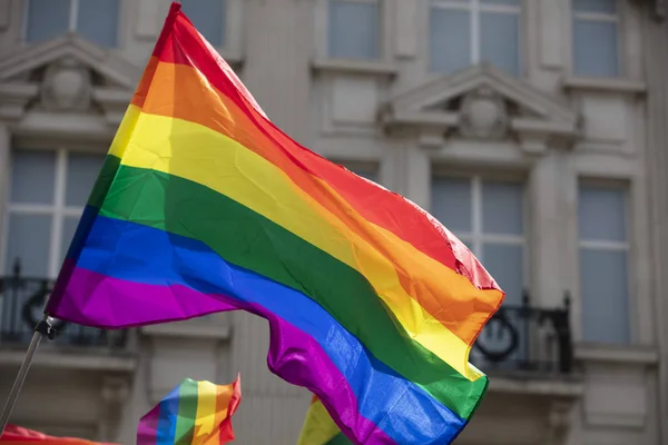 A LGBT gay pride rainbow flag being waved at a pride community celebration event — Stock Photo, Image
