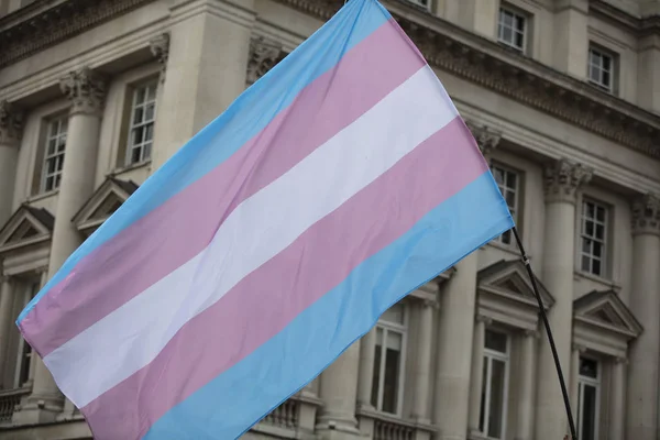 Трансгендерный флаг, размахиваемый на гей-марше ЛГБТ — стоковое фото