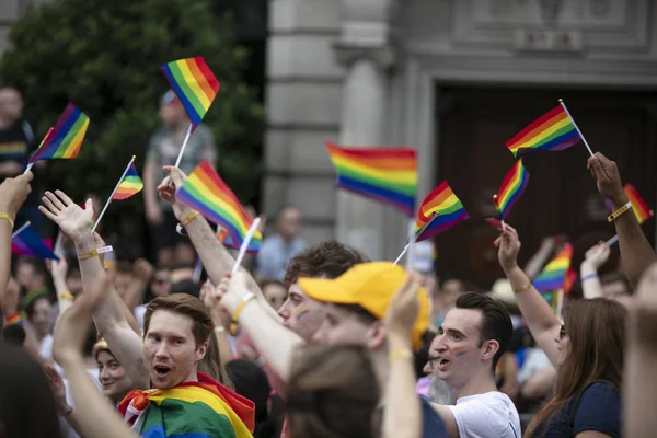 LONDON, UK - July 6th 2019: People wave LGBTQ gay pride flags at a solidarity march — Stock Photo, Image