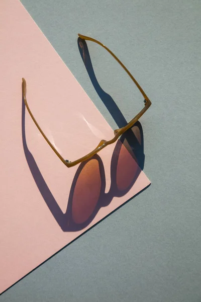 Όμορφα καλοκαιρινά γυαλιά ηλίου με μακρά σκιά σε ροζ και μπλε φόντο — Φωτογραφία Αρχείου