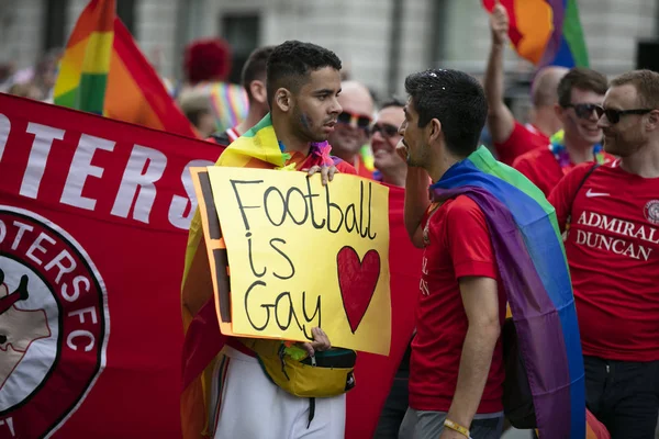 LONDON, UK - July 6th 2019: A man holds a football is gay banner at the annual gay pride march in central London — Stock Photo, Image