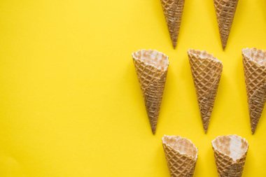 Parlak sarı arka planda boş waffle gofret dondurma koni