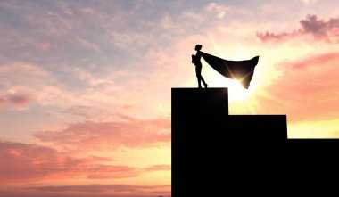 Bir süper kahraman iş kadının silueti karşı bir Cape giyen 