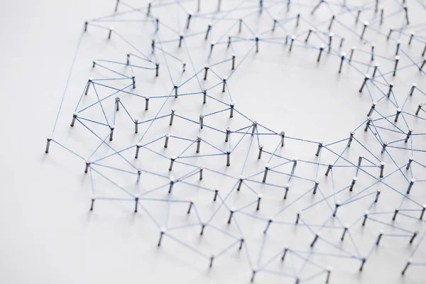 A large grid of pins connected with string. Communication, techn — Stock Photo, Image