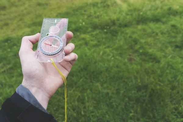 Male explorer with a compass in her hand. Point of view — Stock Photo, Image