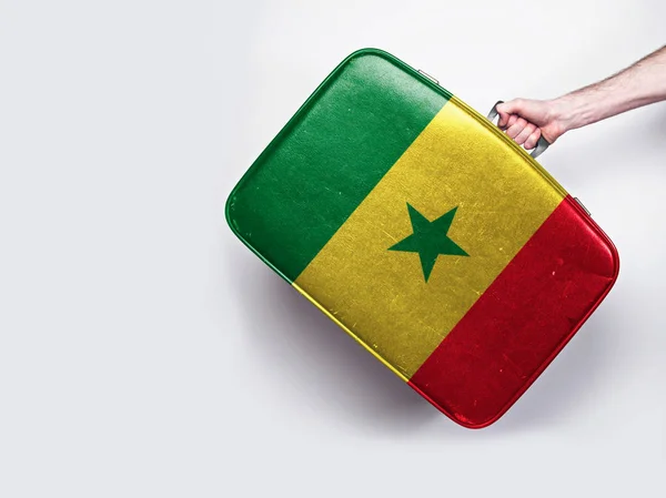 Senegal flag on a vintage leather suitcase. — Stock Photo, Image