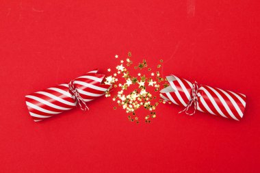 Christmas crackers on a red background clipart