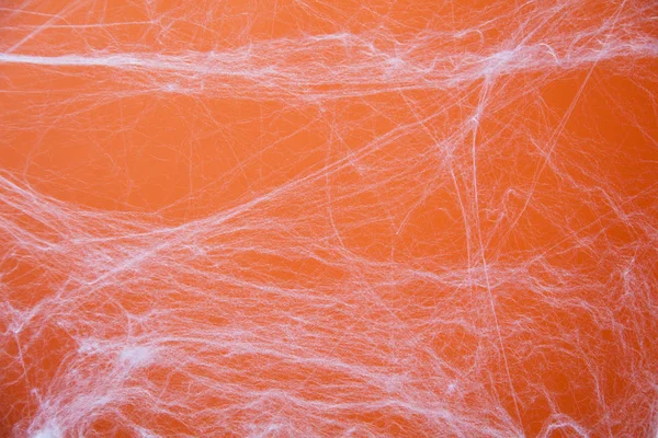 Halloween assustador teia de aranhas teia de aranha com um fundo laranja — Fotografia de Stock