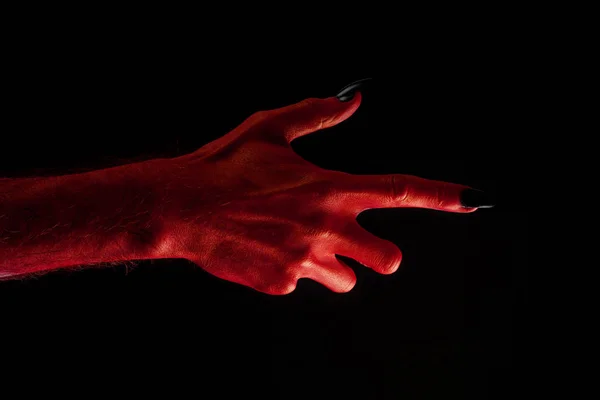 Rode duivel griezelig Halloween hand op een zwarte achtergrond — Stockfoto