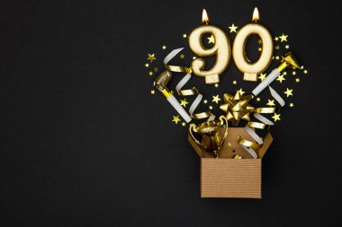 Number 90 gold celebration candle and gift box background clipart