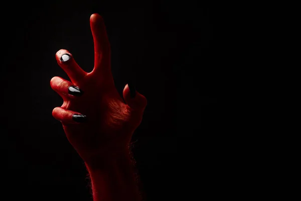 Roter Teufel gruselige Halloween-Hand auf schwarzem Hintergrund — Stockfoto