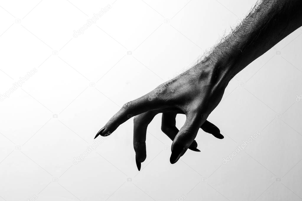 Black creepy halloween monster hand with long nails