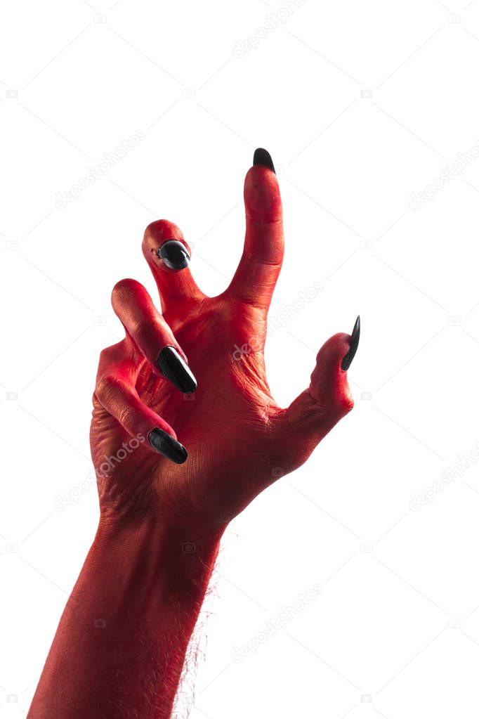 Halloween red devil monster hand with black fingernails against 