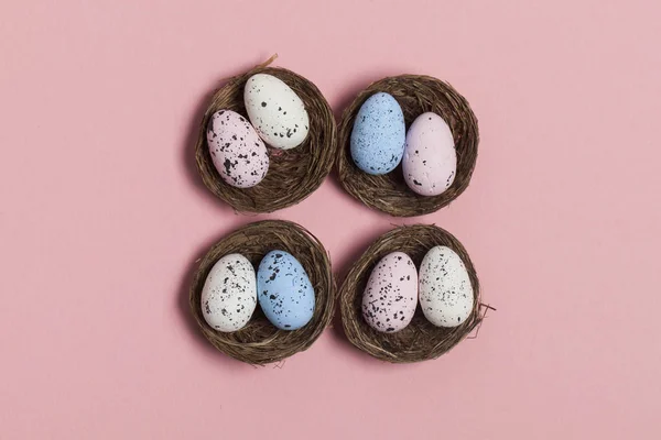 Easter eggs in a nest on a pastel pink background — Stock Photo, Image