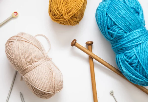 Knitting background. Balls of wool and knitting needles on a pla — Stock Photo, Image