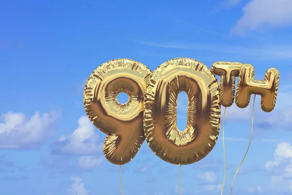 Gold number 90 foil birthday balloon against a bright blue summe — Stock Photo, Image