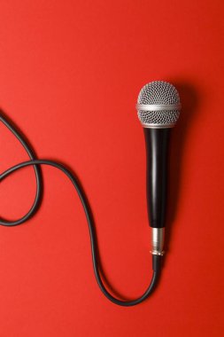 microphone and lead on a bright red background. clipart